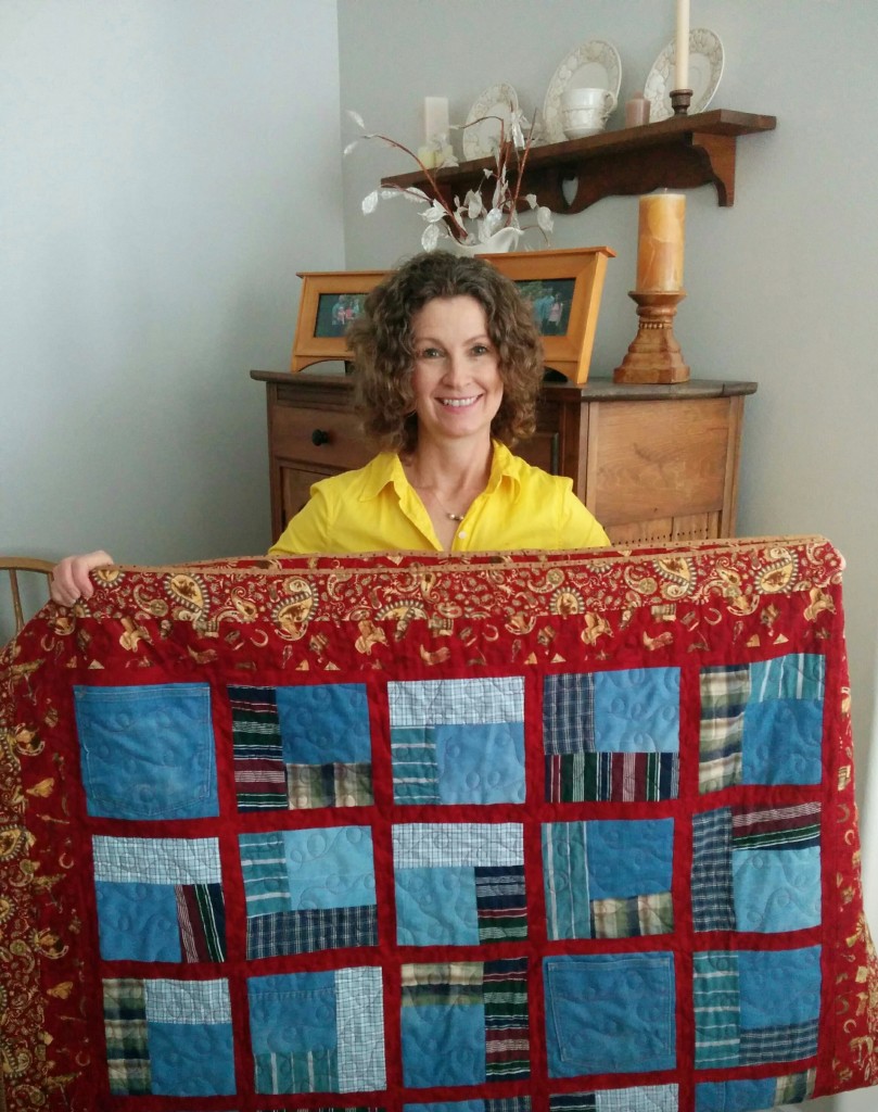 Diana holding her dad's quilt
